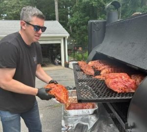 Slow smoked meat in smoker South Shore catering event